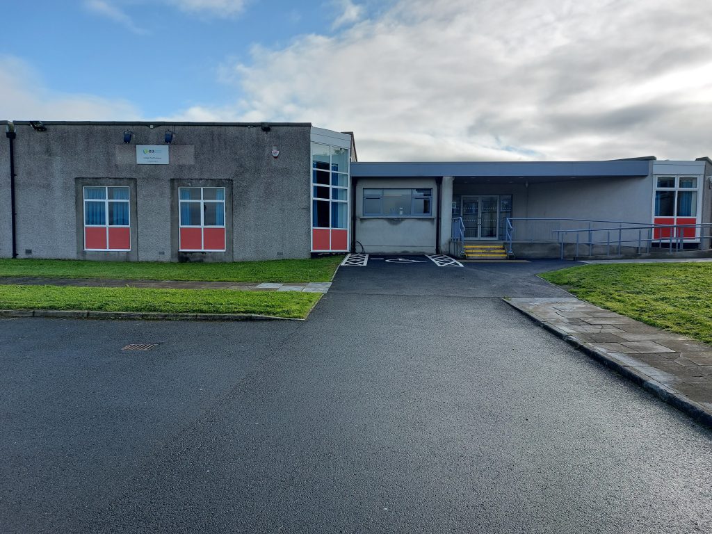 Front of Lurgan youth annexe. the building is a grey building with large windows and red panels.