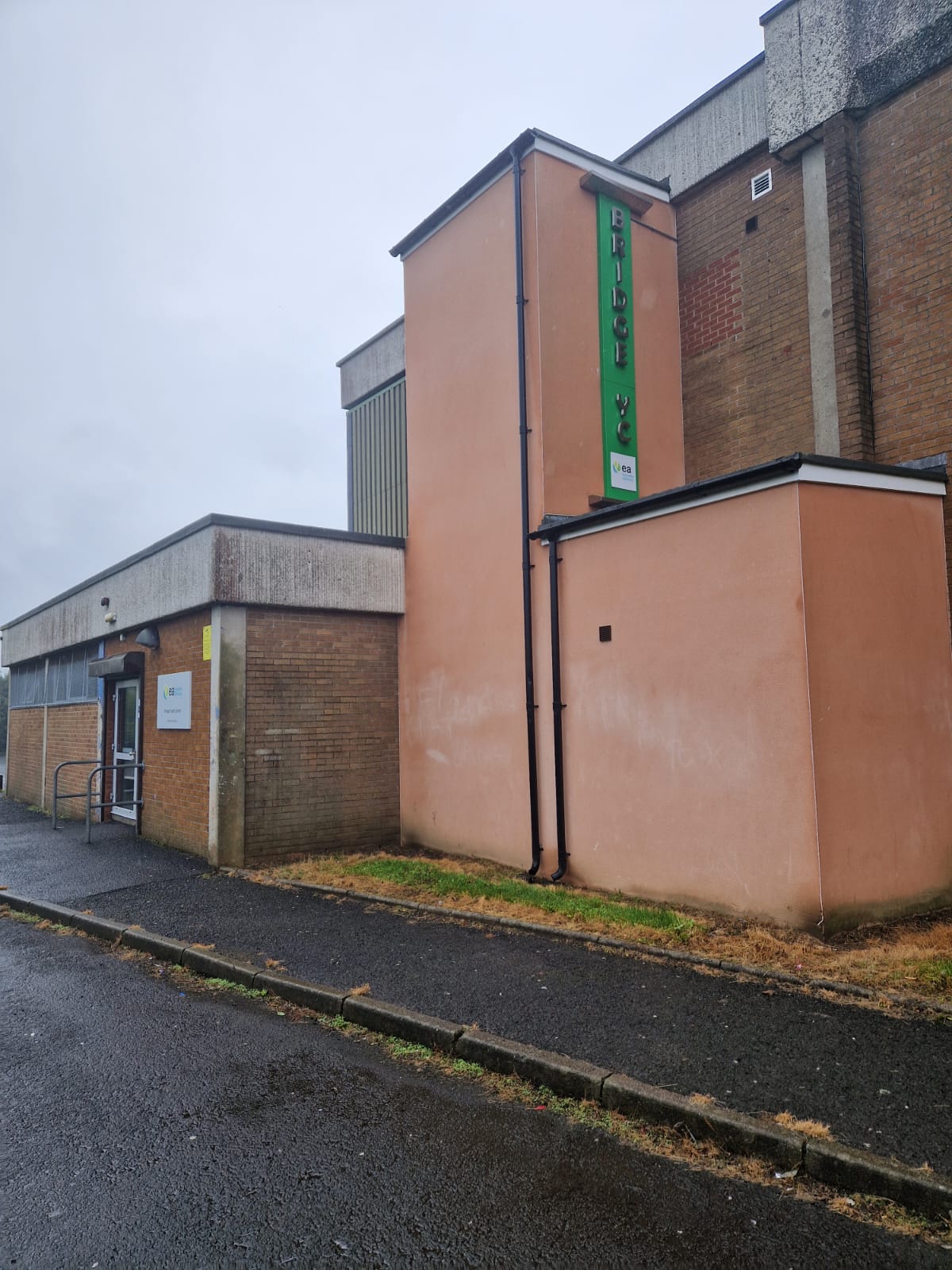 Front of Bridge Youth Centre. The building is painted orange with a green sign saying "Bridge Youth Centre"