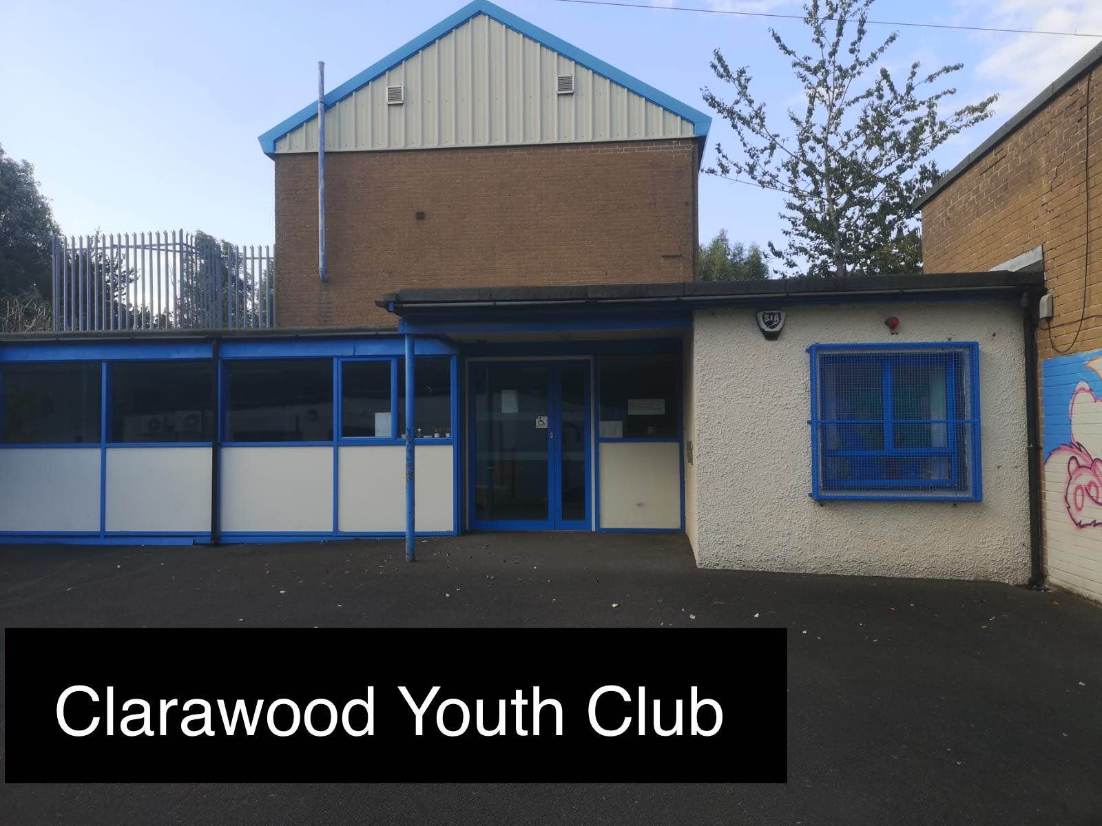Front of Clarawood youth centre, a cream building with blue windows & doors.