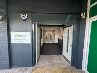 Front door of St Michael Youth Centre. The front door is open and a long corridor can be seen inside.
